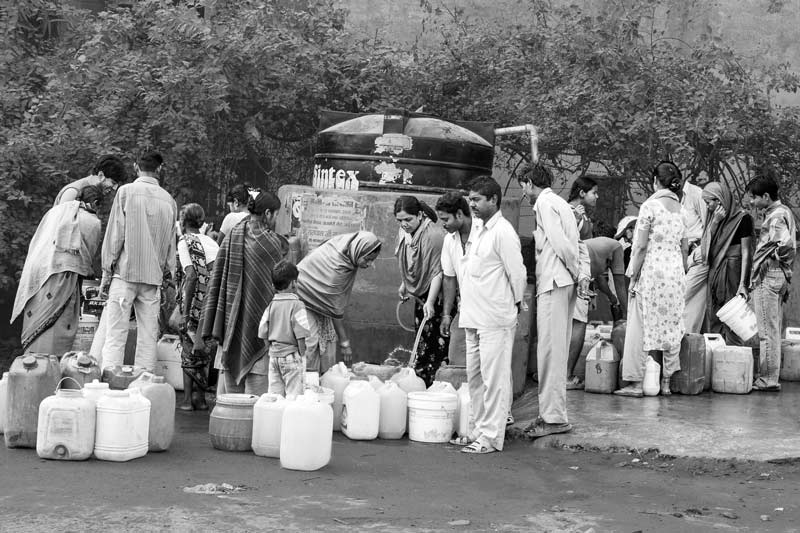 Human Right to Water in Delhi - A public water hydrant shared by multiple households near a slum in Delhi